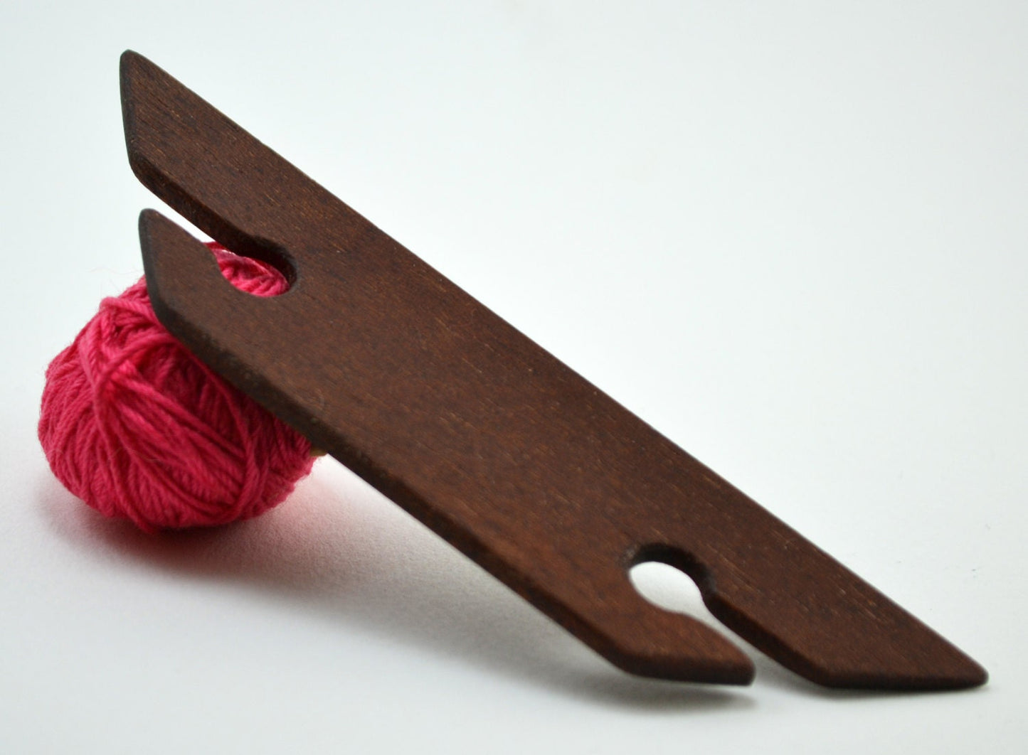 Small 4.5 inch beveled weaving shuttle. Handcraftd from mahogany by Wiener Dog Ranch. Back.